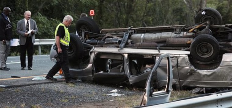 State police investigate the scene of a fatal accident on Sept. 18 in Woodbury, N.Y. A passenger van carrying members of a church flipped over on the New York State Thruway, killing at least six people and injuring eight others, authorities said. 